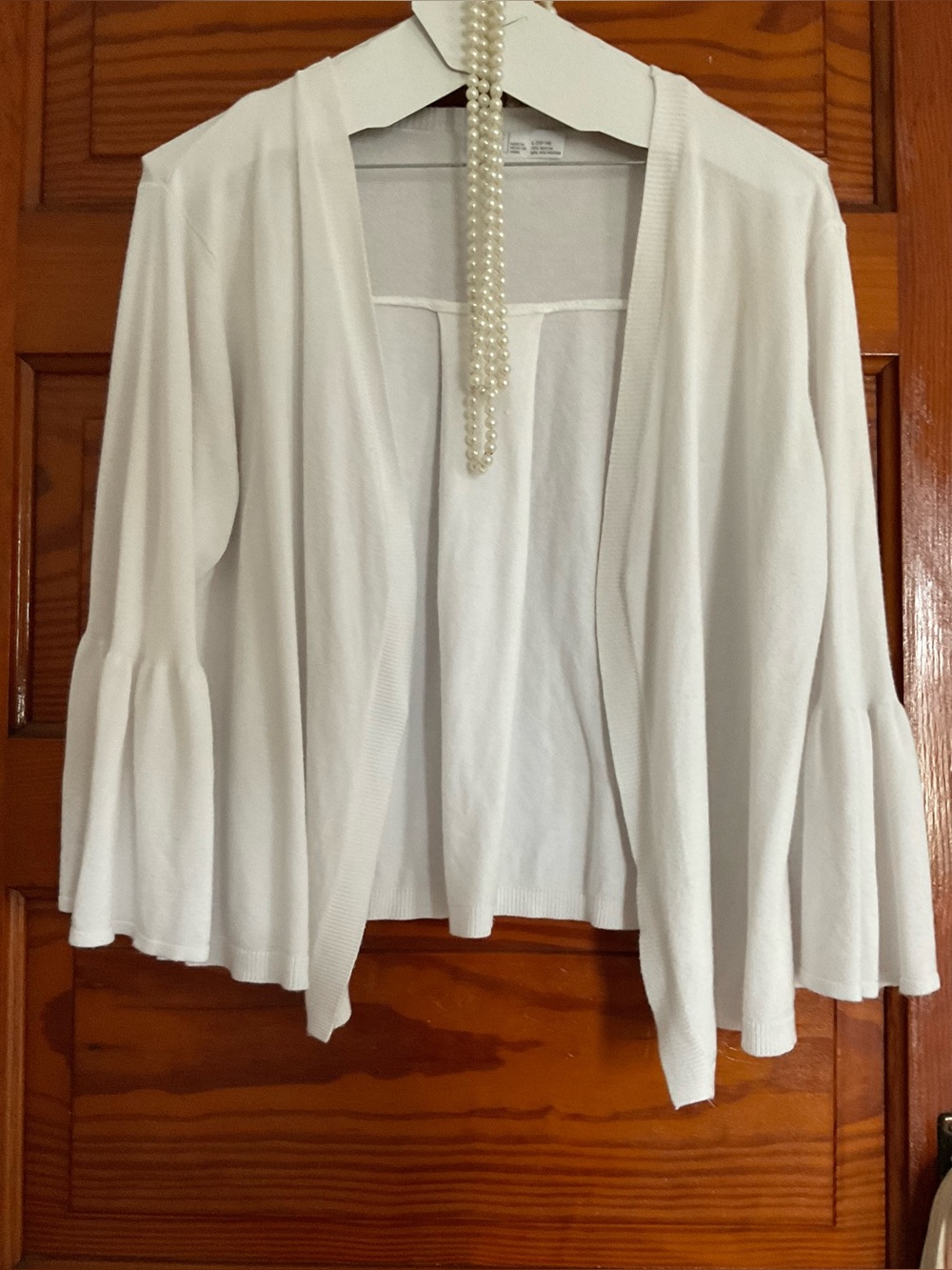 white sweater with ruffled sleeves